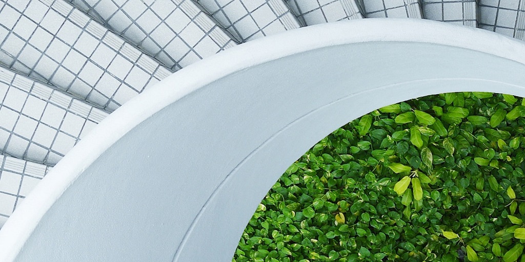 Woman standing spiral stairs to grass